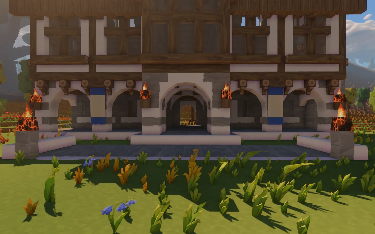 Ivory banners with blue hems hanging beside the timber hall's stone arcade, with torches and braziers alight.
