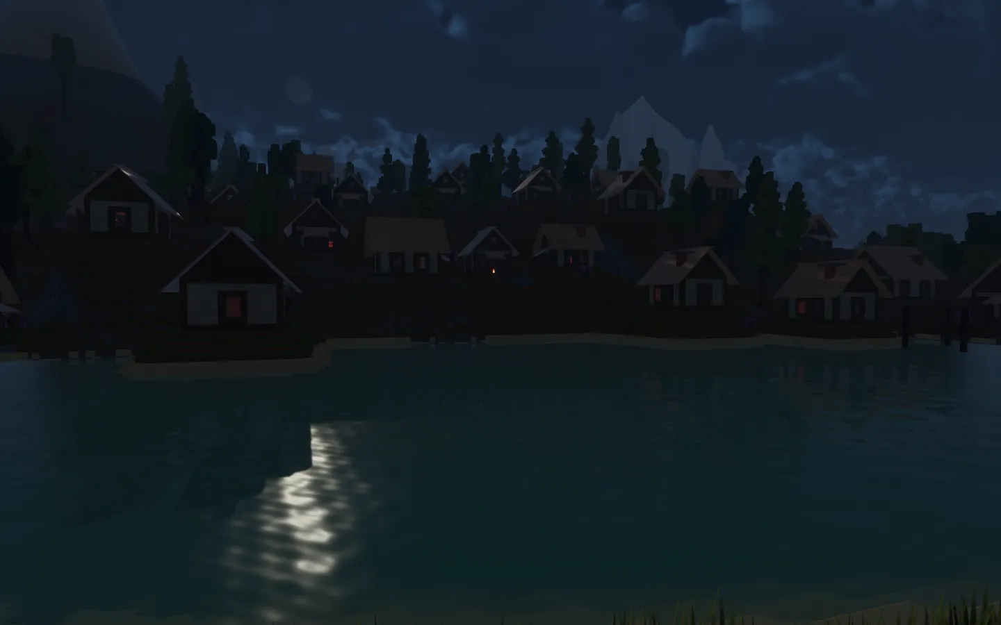 The lakeside village under moonlight, with dark cottages, trees and their reflections across blue water.
