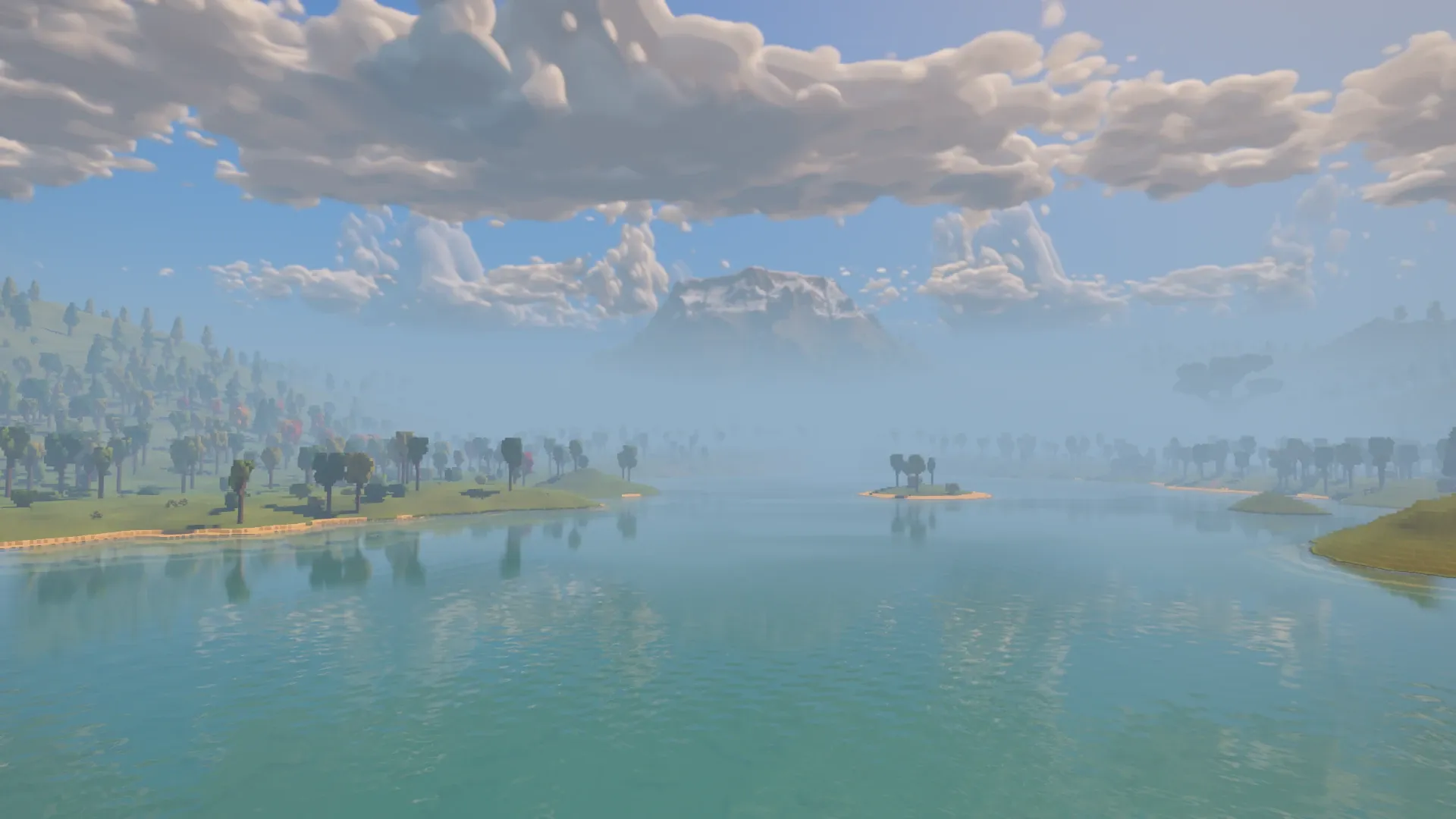 After the skyline update, the same lake view reveals the snowy mountain above the low haze and wooded shores continuing into the distance.