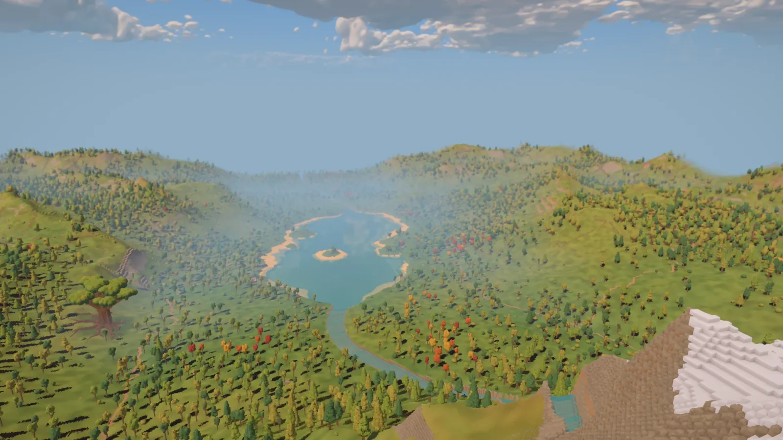 A view from the snowy summit across the river, lake, ancient tree and wooded hills extending to the valley's distant rim.