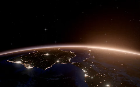 Earth's night side as the Sun clears its limb, where The Crossing ends