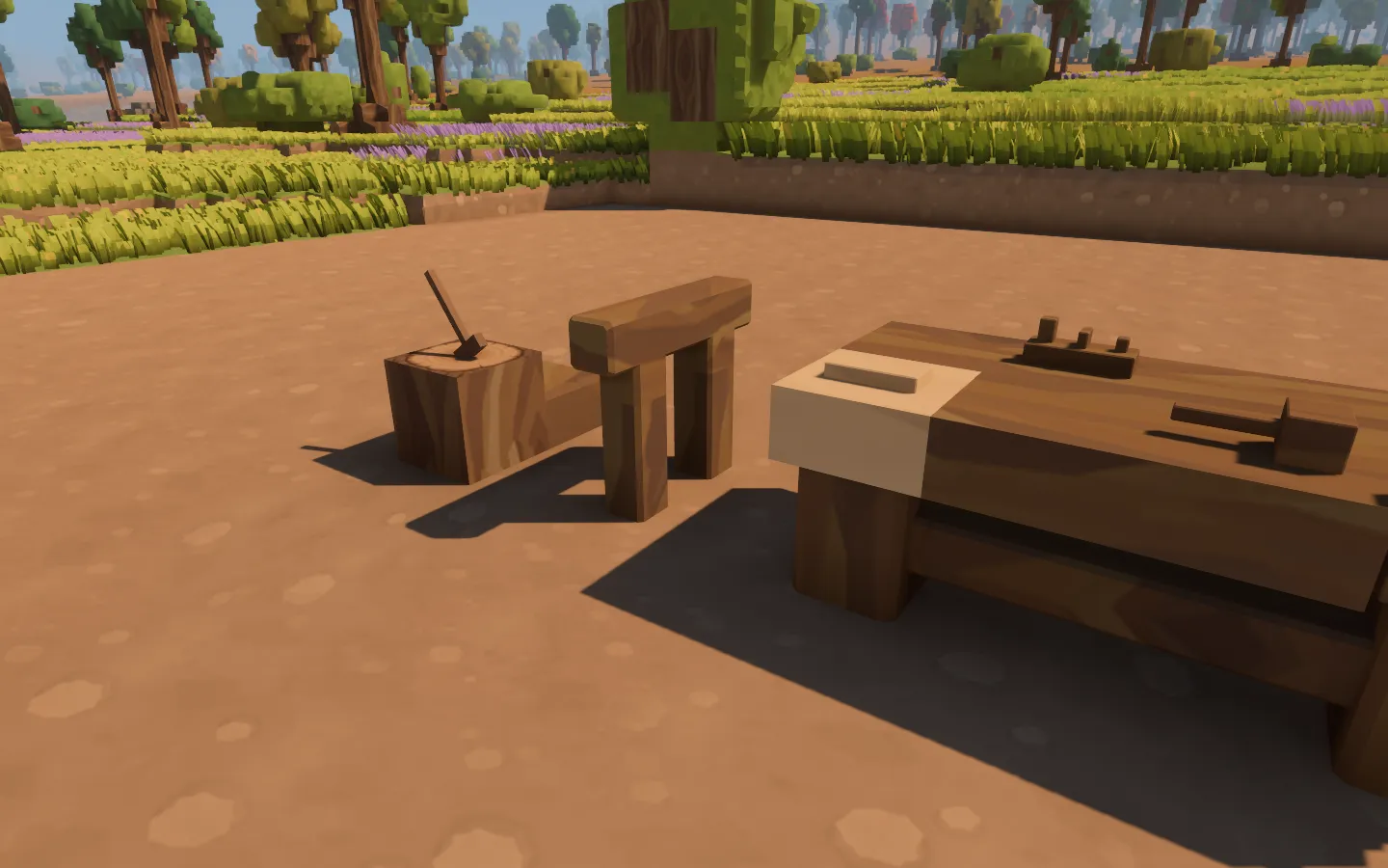 A wooden workbench with small tools on its top, a sawhorse beside it and an axe resting in a block of wood.