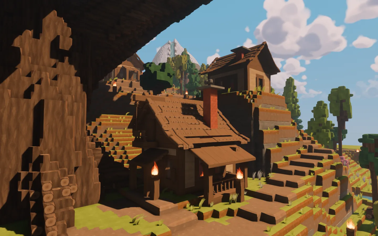 The workshop beside the Hearth Tree, with its low roof, brick chimney, covered work area and timber stock.